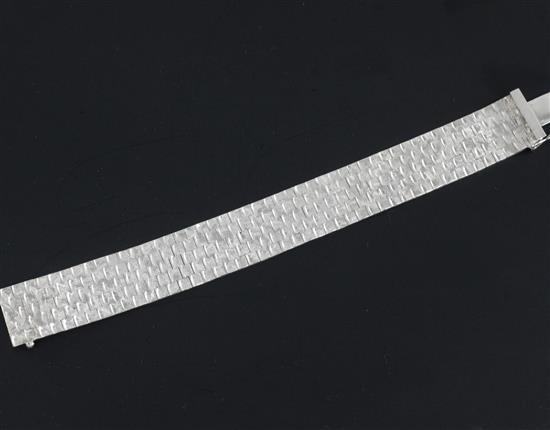 A 1970s bright cut engraved 9ct white gold bracelet, 7.25in.